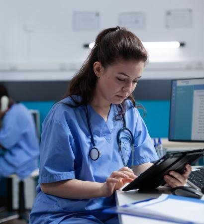 Pharmacist nurse looking at tablet computer analyzing sickness expertise working at healthcare treatment in hospital office. pediatrician asisstance checking pharmaceutical medication sitting at desk